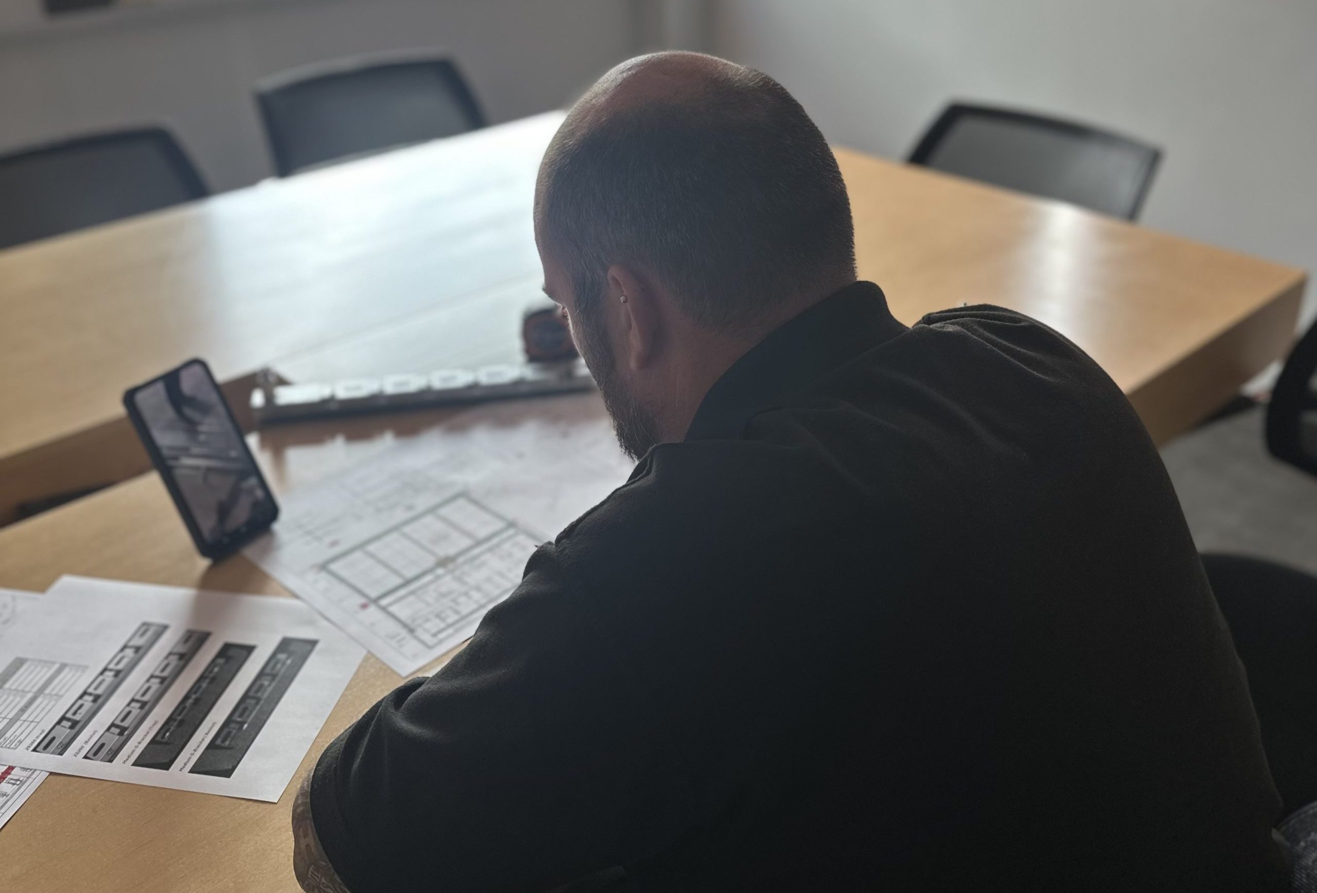Zip-Clip technical team member reviewing a project drawing during a video call